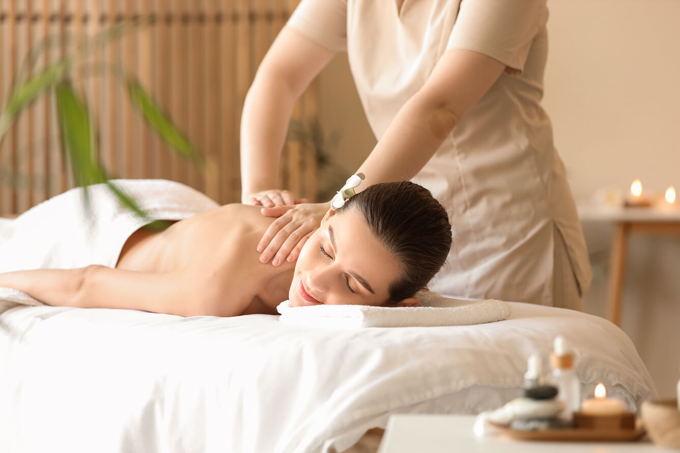 Woman receiving traditional Asian back massage in Venice spa