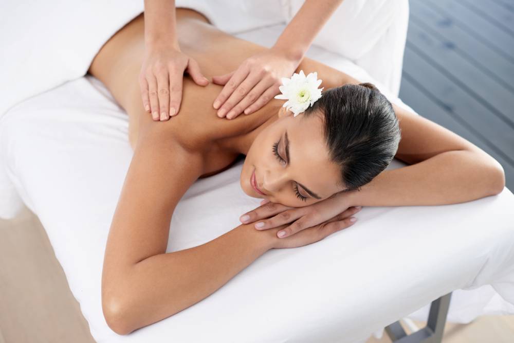 Traditional Asian massage with floral accents at Venice spa