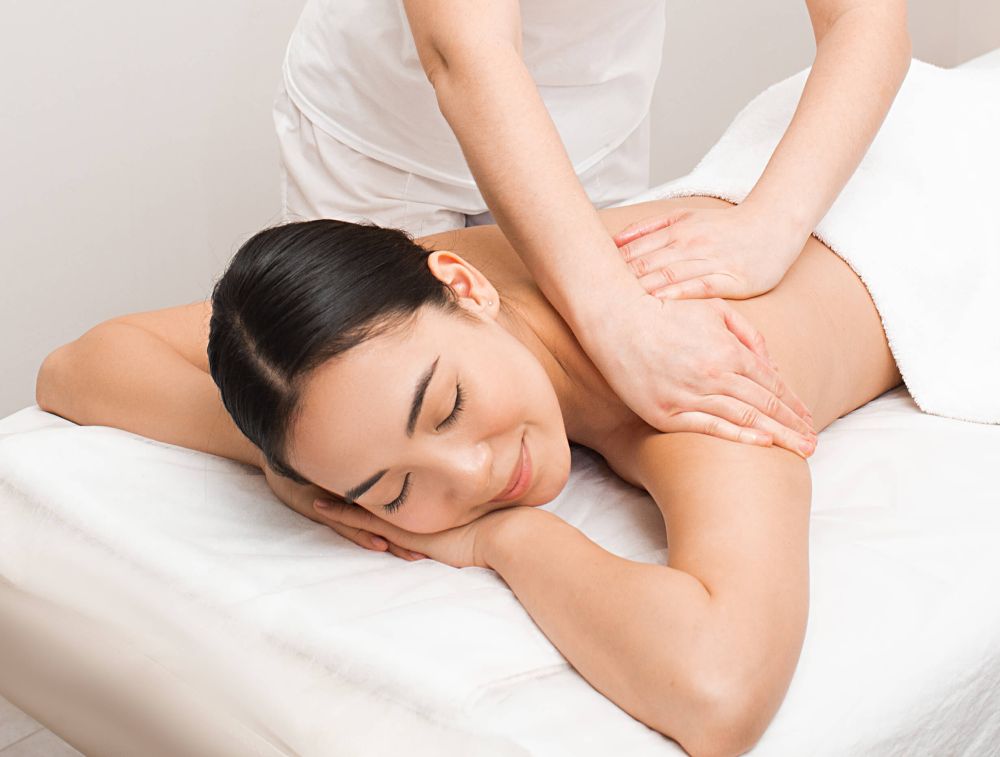 Client enjoying personalized full-body massage session
